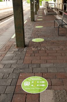 Social distancing floor signs at the railway station due to a coronavirus safety rules