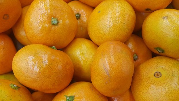 Fresh oranges in supermarket for sale, pile of orange in market for texture