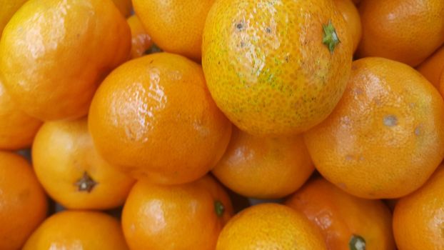 Fresh oranges in supermarket for sale, pile of orange in market for texture