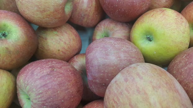 Fresh red and green Apples pile in market for sale. Fruit background for text or messages