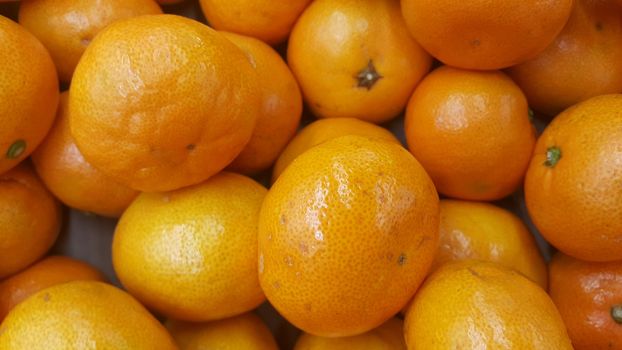 Fresh oranges in supermarket for sale, pile of orange in market for texture