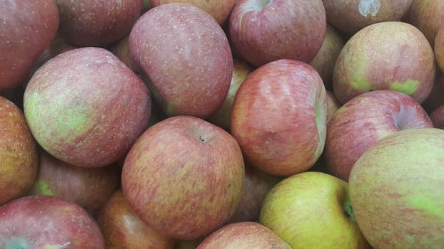 Fresh red and green Apples pile in market for sale. Fruit background for text or messages