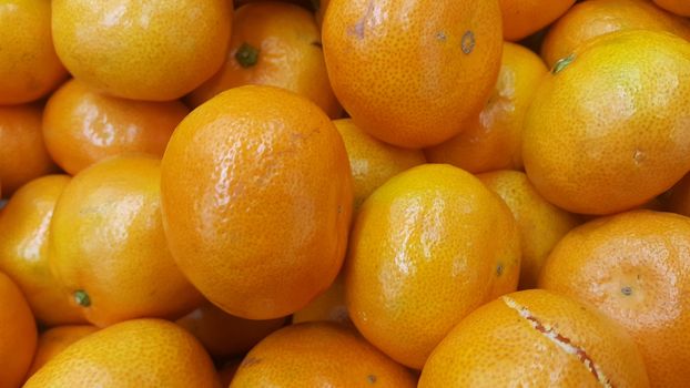 Fresh oranges in supermarket for sale, pile of orange in market for texture