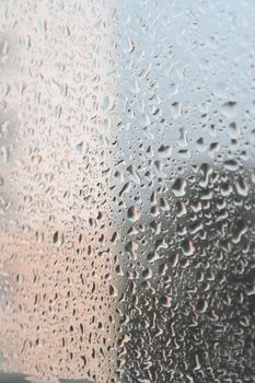 On a summer raining day. Drops of water on the window. Shallow DOF