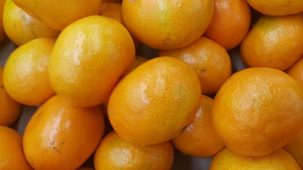 Fresh oranges in supermarket for sale, pile of orange in market for texture