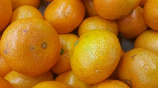 Fresh oranges in supermarket for sale, pile of orange in market for texture