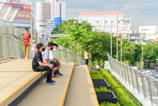 Bangkok , Thailand - 1 July, 2020: People walking and sitting in relax at Chao Phraya Sky Park  landmark in Bangkok
