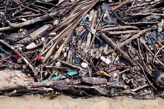 Garbage pile deposit Branches wood, Pile of wood and plastic bottles waste and debris floating on water surface at river water dirty, Problem of trash pollution and environmental on the beach or river