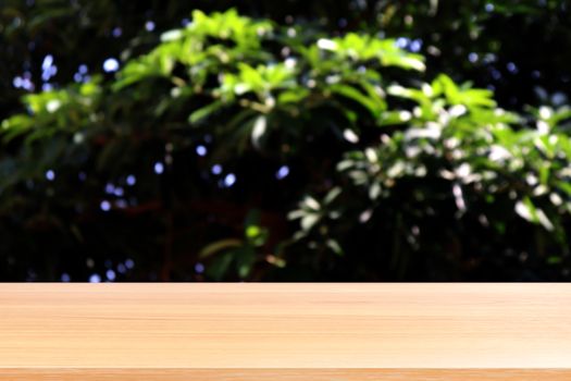 empty wood table floors on blurred tree nature green forest background, wood table board empty front blur tree, wooden plank blank with perspective brown wood table for mock up display products