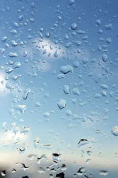 Abstract background, water drops on a window glass, rainy day