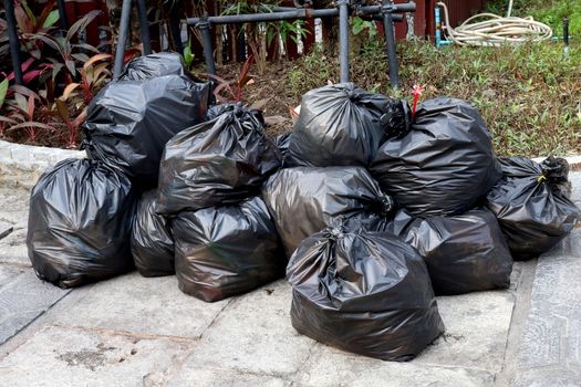 Waste plastic, Lots pile of garbage black bags stack on the floor ground public park, many dump black garbage plastic bags stack