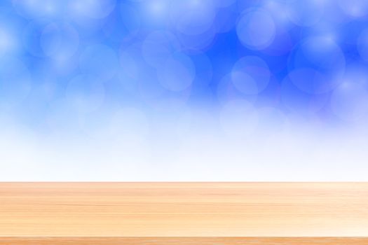 empty wood table floors on blurred bokeh soft blue white gradient background, wooden plank empty on blue bokeh colorful light shade, colorful bokeh lights gradient soft for banner advertising products