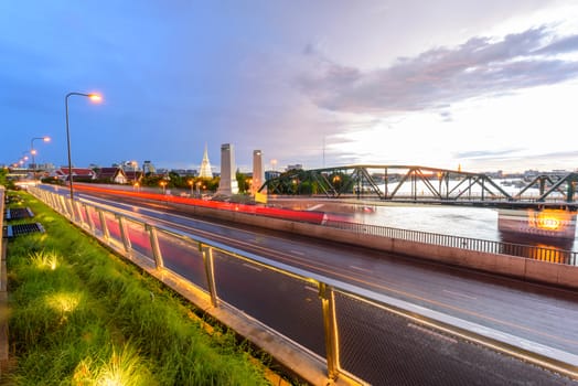 Bangkok , Thailand - 1 July, 2020:  Blur light of car traffic view front side of the Chao Phraya Sky Park in sunset time