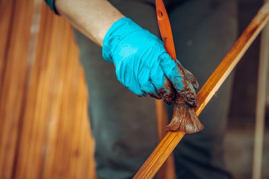 varnishing of wooden slats with a protective coating with a color shade.