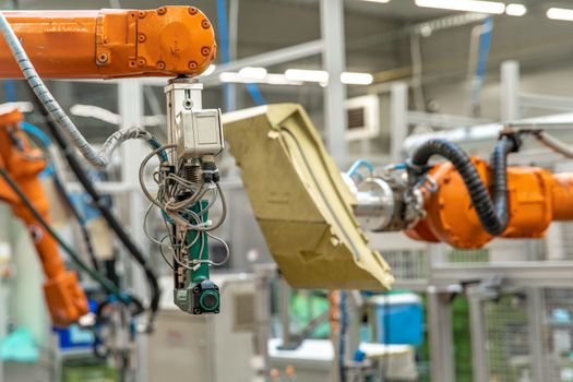 use of robotic arms in the production of cars in the automotive industry.