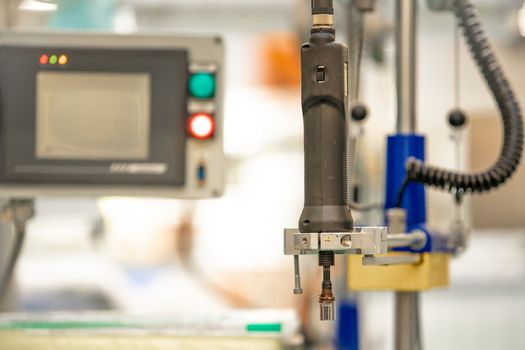 electric screwdriver and grinder on the production line in the factory.