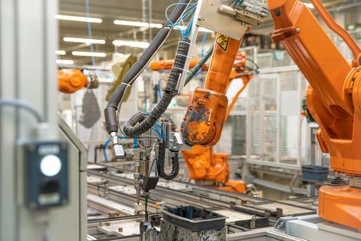 use of robotic arms in the production of cars in the automotive industry.