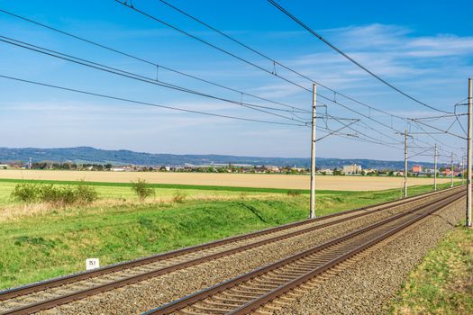 Railroad tracks in the beautiful green landscape.