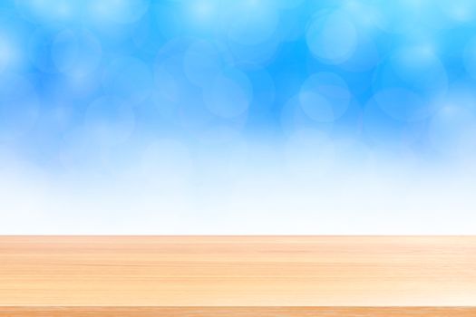 empty wood table floors on blurred bokeh soft blue white gradient background, wooden plank empty on blue bokeh colorful light shade, colorful bokeh lights gradient soft for banner advertising products