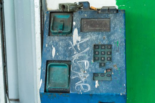 Old broken payphone. Traces of poverty and devastation