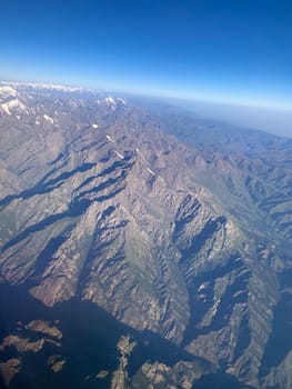 the view from the airplane, flying over the mountains area. Aerial photography