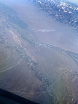 the view from the airplane, flying over the mountains area. Aerial photography