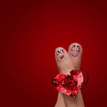 the happy finger couple in love with painted smiley and hold diamond ring heart shape