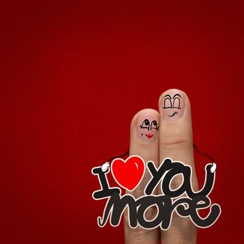 the happy finger couple in love with painted smiley and hold word love you more