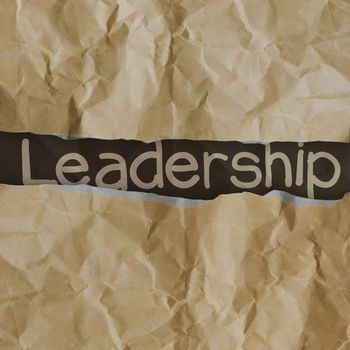 hand drawn  leadership words on crumpled paper with tear envelope as concept