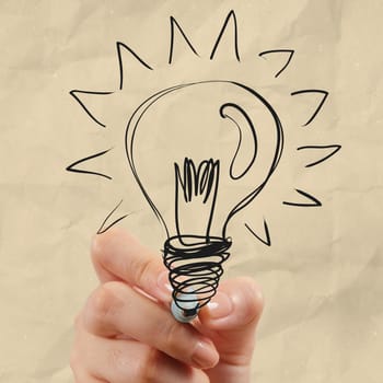 hand drawing light bulb with crumpled paper as creative concept