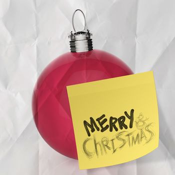 Empty Christmas ball ornament on crumpled paperand sticky note background