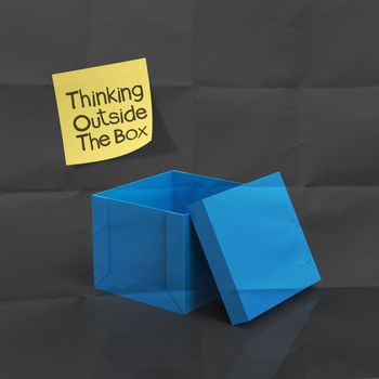 sticky note with thinking outside the box on dark crumpled paper as concept