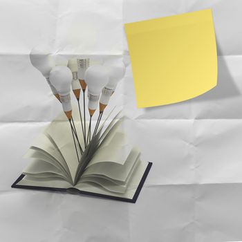 blank yellow stucky note with idea pencil and light bulb concept crumpled paper background