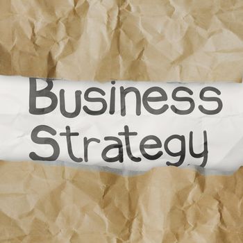 hand drawn  business strategy words on crumpled paper with tear envelope as concept