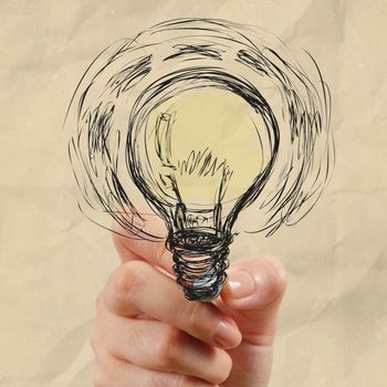 hand drawing light bulb with crumpled paper as creative concept