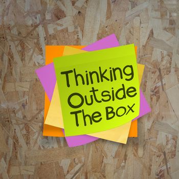 thinking outside the box sticky notes on recycle wood desk top as concept