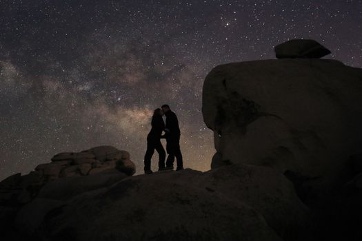 Happy Couple Silhouette Under the Stars at Night