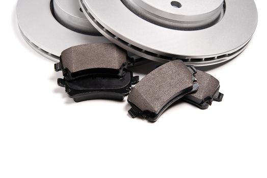 brand new brake discs and brake pad set for car. isolated on white with copy space