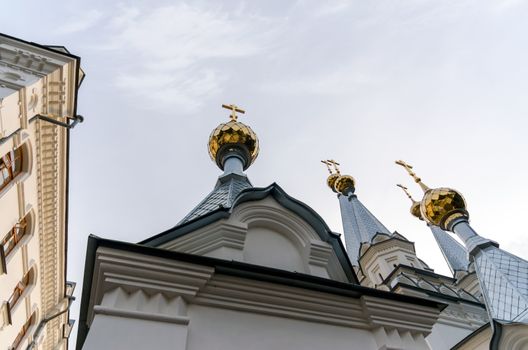 bottom view domes of christian church with crosses on blue sky background in Ukraine