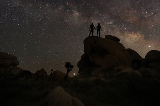 Happy Couple Silhouette Under the Stars at Night