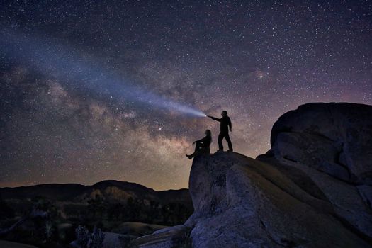 Happy Couple Silhouette Under the Stars at Night