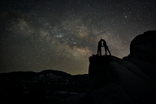 Happy Couple Silhouette Under the Stars at Night