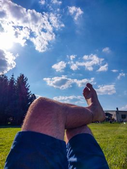 Feet of a man relaxing in shorts during a sunny day