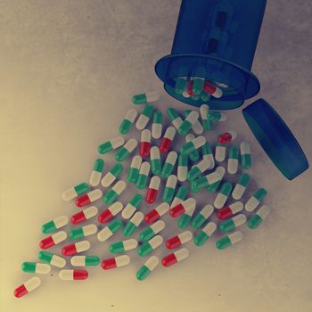 3d Pills spilling out of pill bottle as vintage style concept