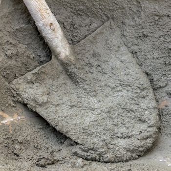 Close-up of an heap of hand mixed concrete with shovel