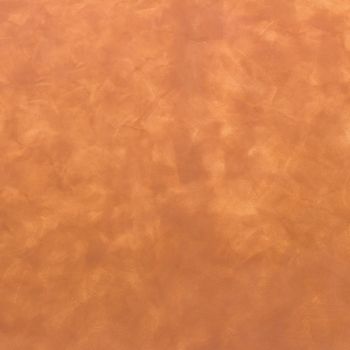 Background of a warm brown wall with rough plaster texture