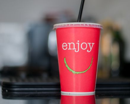 red beaker with drink and straw