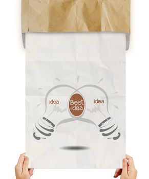 hand pulling light bulb crumpled paperfrom recycle envelope as creative concept