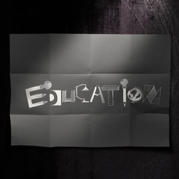 design word EDUCATION on dark crumpled paper and texture background as concept