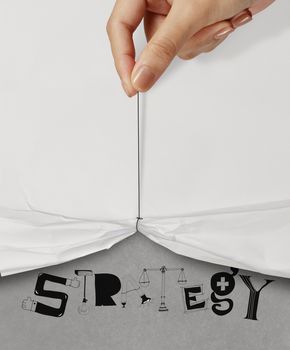 business hand pull rope open wrinkled paper show STRATEGY design text as concept